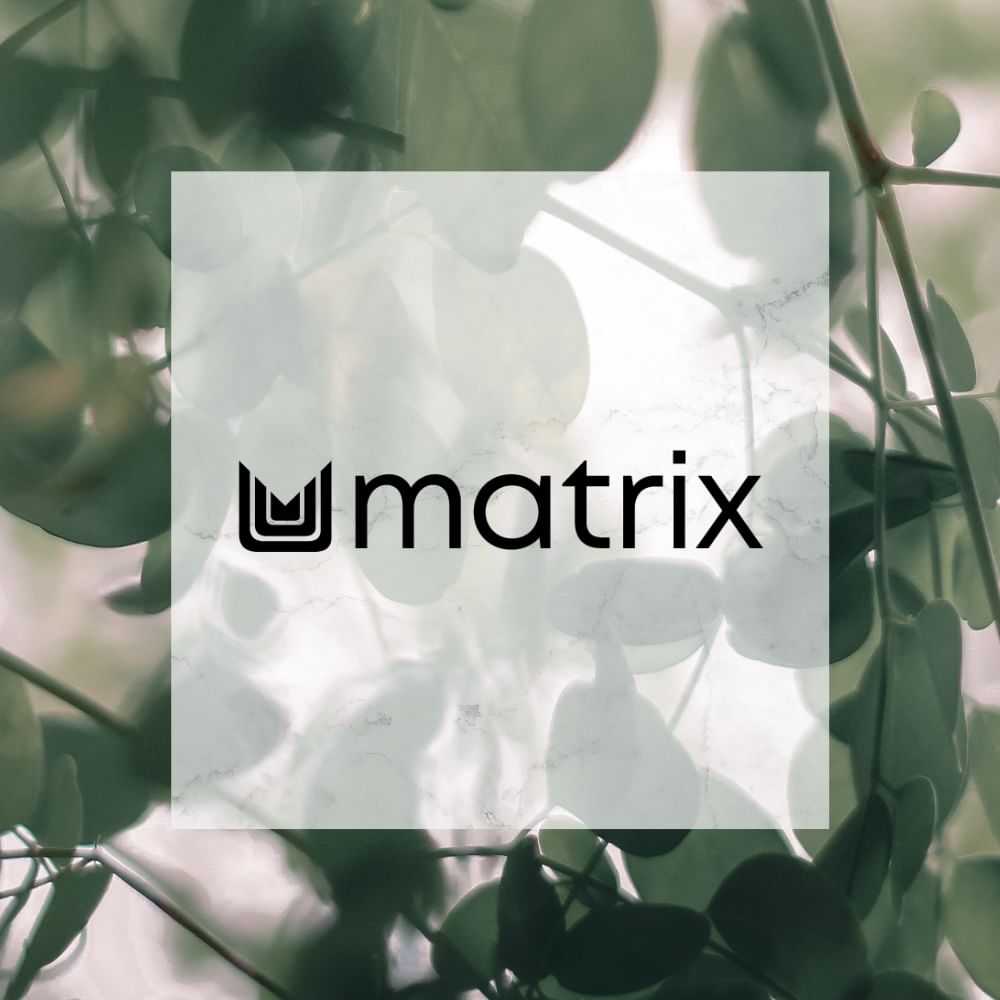 Matrix logo overlaying a background of green, blurred leaves.