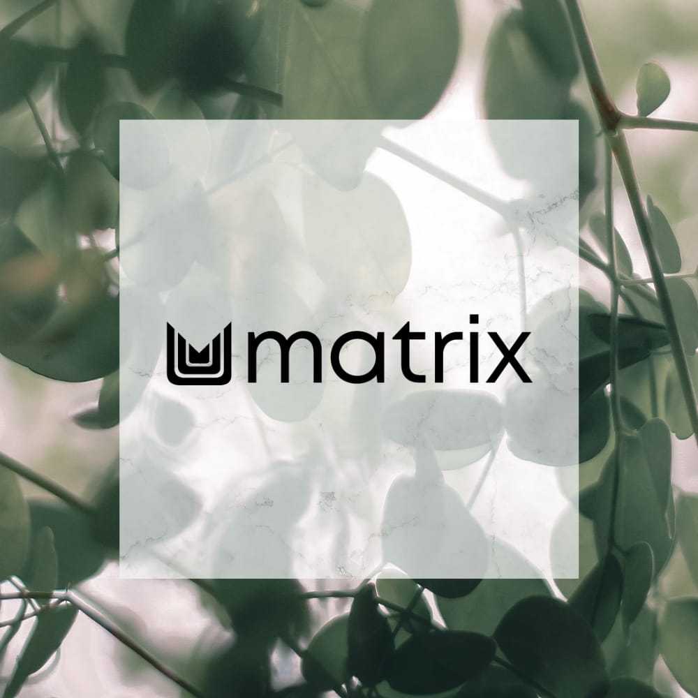 Matrix logo overlaying a background of green, blurred leaves.